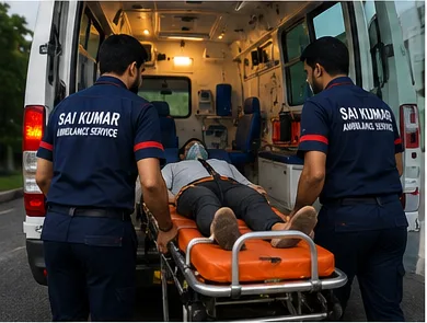 Sai Kumar staff transferring a patient into an ambulance